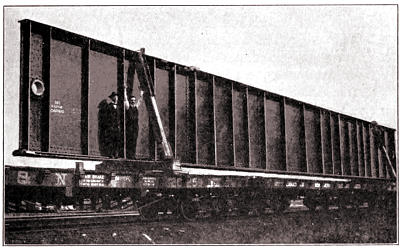 Two Men and a Floor Beam: In Transport To Site On Railroad Car